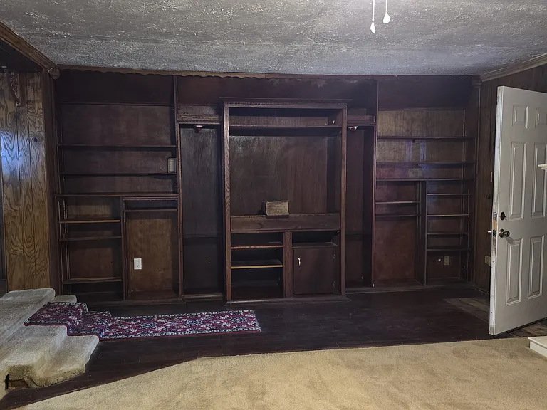 Second family room with built in entertainment center with book shelves and cabinets