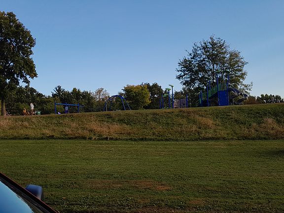 View of playground and park across street from the front yard