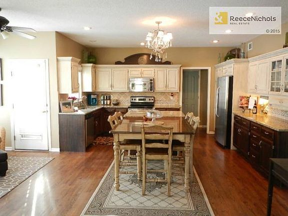 Updated kitchen with newly refinished floors, faux finished cabi