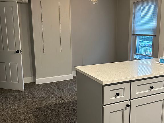Kitchen looking into living room/dining area. Large closet/pantry to the left.
