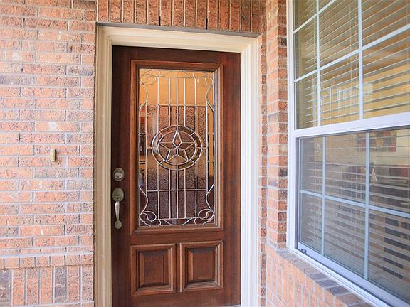 As you approach the front porch, you'll be impressed by the beautiful custom beveled glass door.