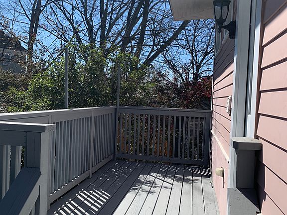 Apt 2 rear deck up in the tree branches with enough sun for a banister garden and room for a grill