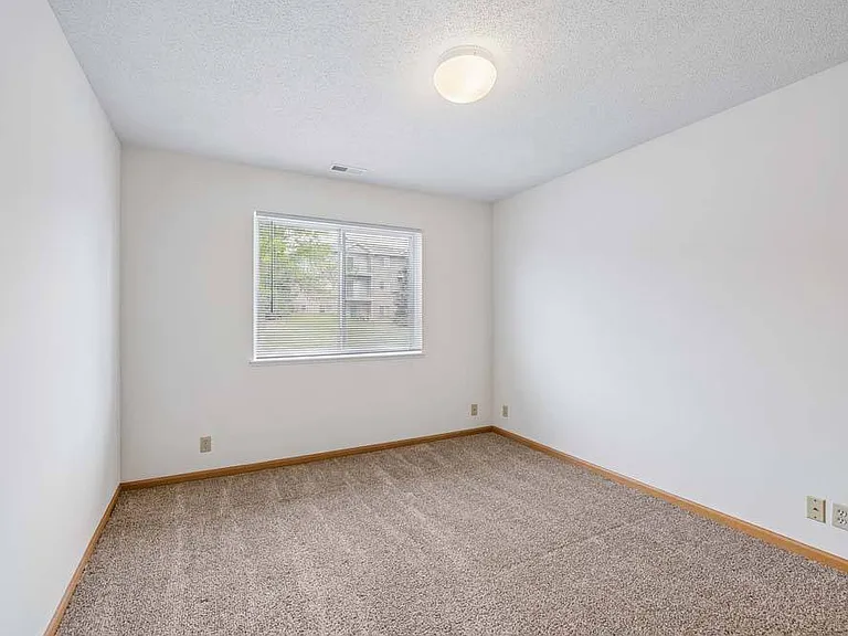 A bright and inviting bedroom offers a comfortable retreat with plenty of space to relax and personalize.