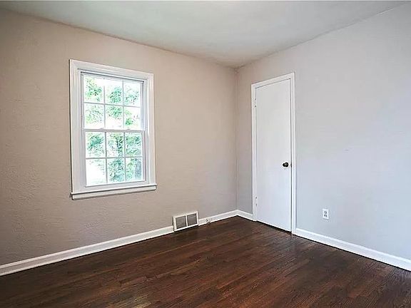 All three bedrooms on the main level are about the same as this one. all with hardwood floors