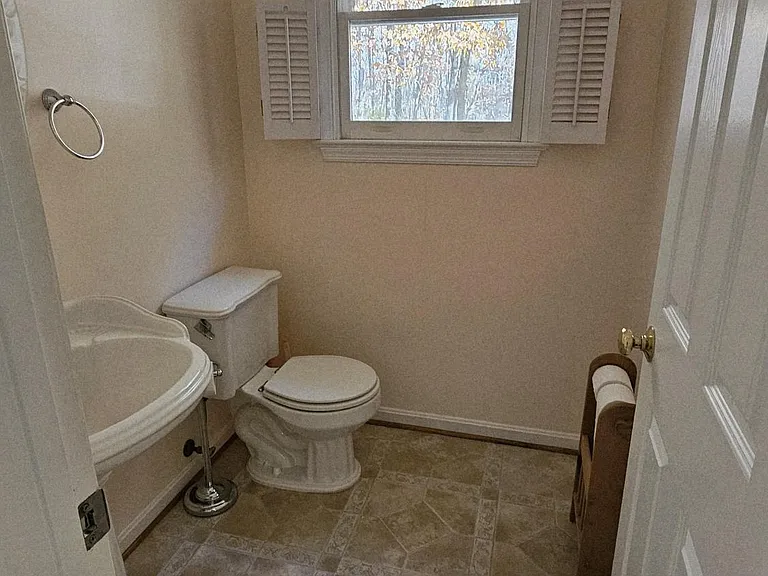 Powder room on 1st floor off the kitchen and across the laundry room/mudroom