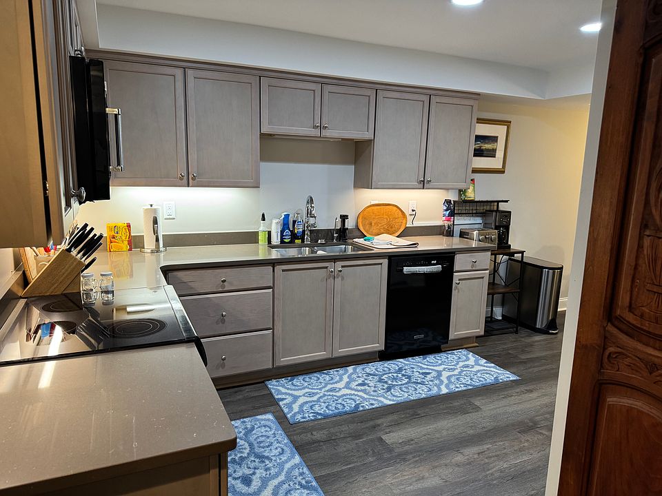 Fully equipped kitchen with electric range, microwave, dishwasher and refrigerator. Contains all the essentials, making living easy.