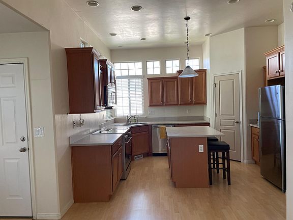 Kitchen with new stainless steel appliances. Walk-in pantry.