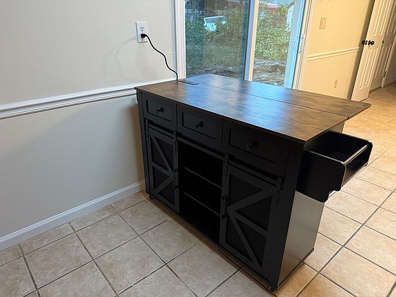New kitchen island on wheels that can be moved to suit your needs. Adds additional storage