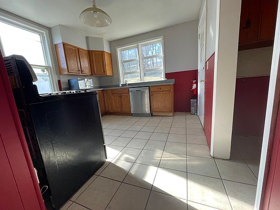 Modern eat-in kitchen featuring Samsung stainless steel appliances and plenty of counter space.