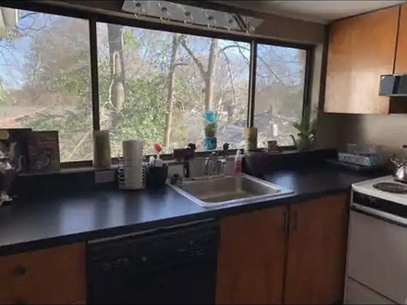 galley kitchen has two cabinets set our floor to ceiling reach pantries, dishwasher, garbage disposal, butcher block counters space