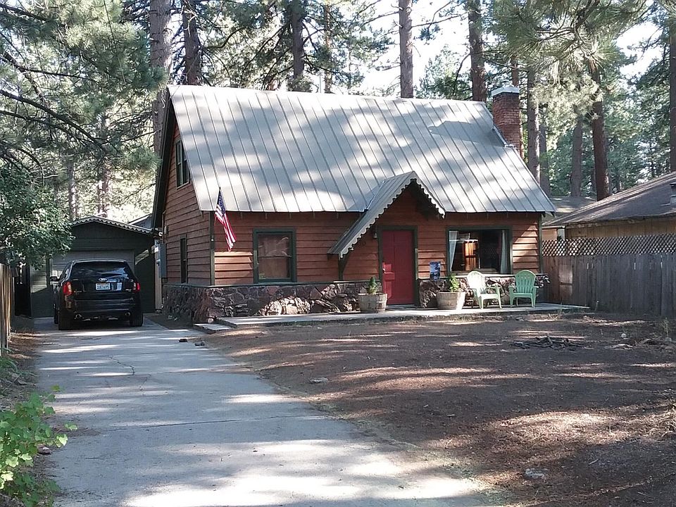 Cabin set back from street with ample parking.
