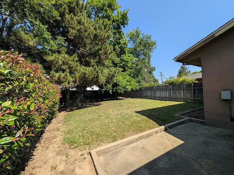 Fenced backyard with patio