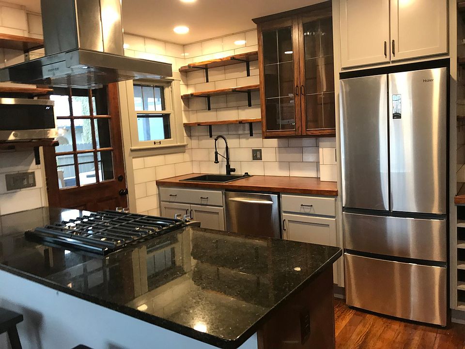Industrial design kitchen with both shelves and cupboards.