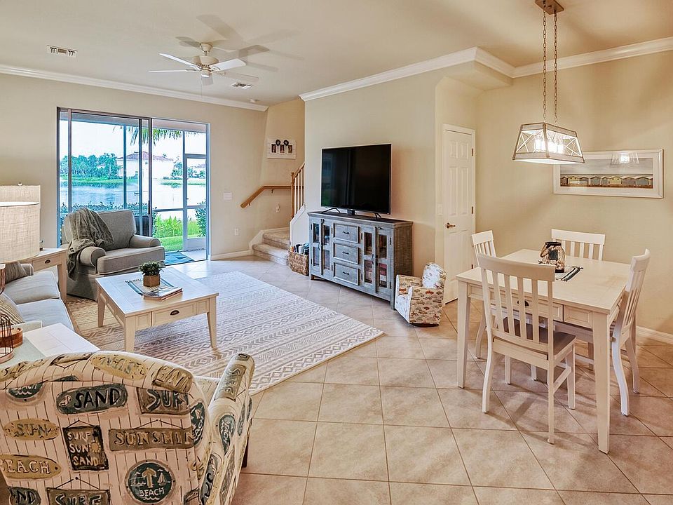 Beautifully decorated coastal living area with high ceilings. Very light and airy with a view looking into the Lanai area and toward the lake with fountains