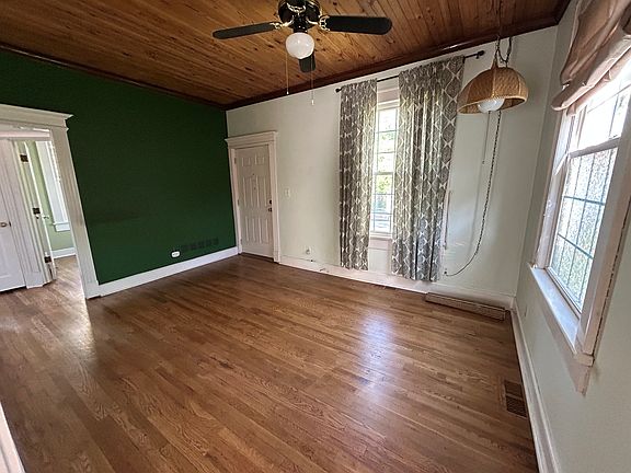 Living room and front door. A doorway leads to the bedrooms.