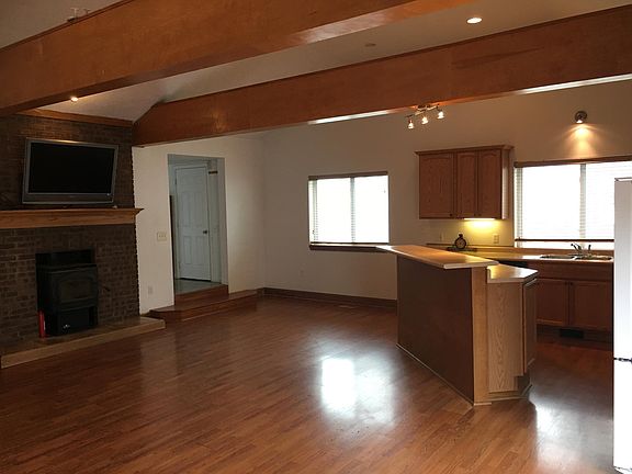Spacious family room with a kitchen and walkout stamped pati