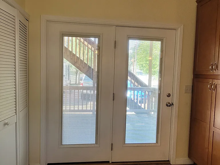 Washer and dryer in the closet to the left. Back doors have internal privacy shades; open in this picture