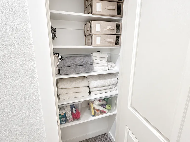Linen closet inside master bedroom hallway