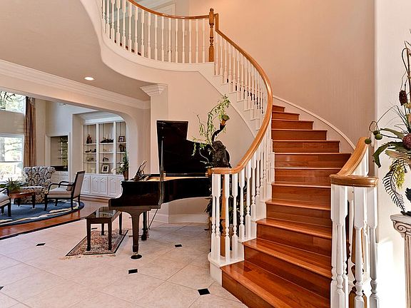 Graceful curved staircase welcomes you.