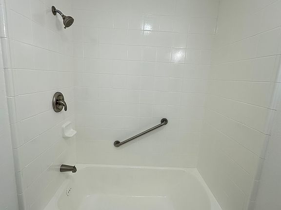 Refinished bath tub and shower.