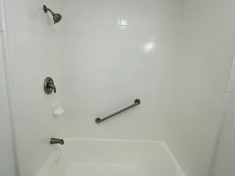 Refinished bath tub and shower.
