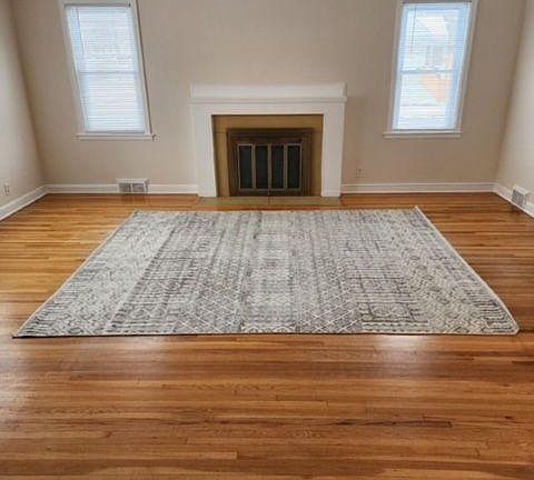 large, bright and open living room with fireplace.