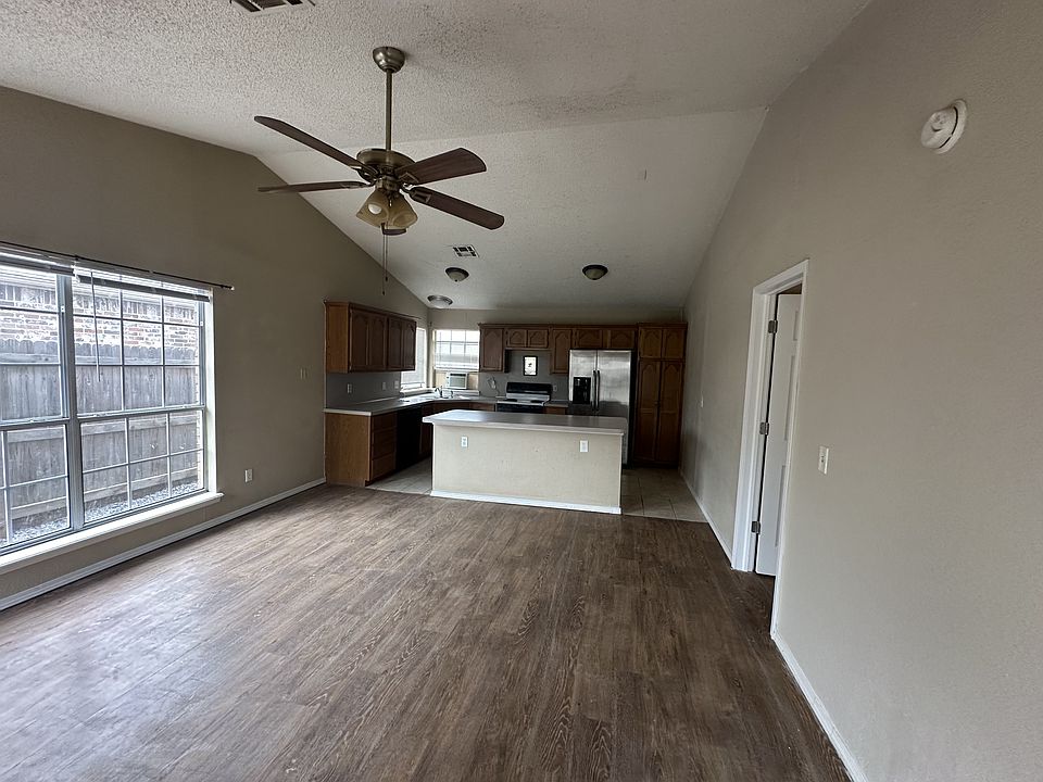 Living area with updated vinyl flooring - freshly painted walls (color may vary by lighting).