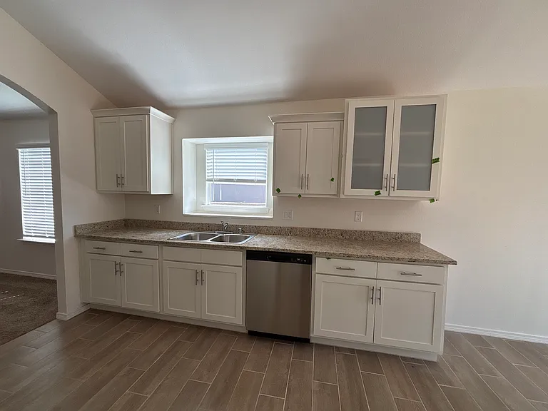 Modern kitchen featuring granite countertops, stainless steel appliances, ample cabinet space, and an open layout perfect for everyday living