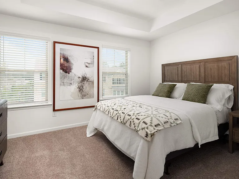 Secondary bedroom with queen size bed and large window letting in a ton of natural light.
