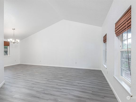 Glance at the tall ceilings allowing for an open & spacious living room.>