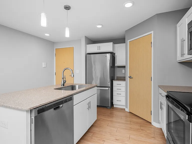 Modern kitchen with sleek stainless steel appliances, elegant pendant lighting, and spacious countertops, perfect for gourmet cooking. Modern kitchen with sleek stainless steel appliances, elegant pendant lighting, and spacious countertops, perfect for go