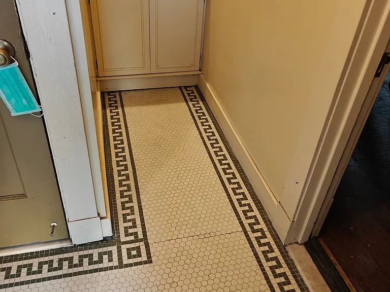 Front entrance foyer features lovingly restored original penny tile and plenty of storage.