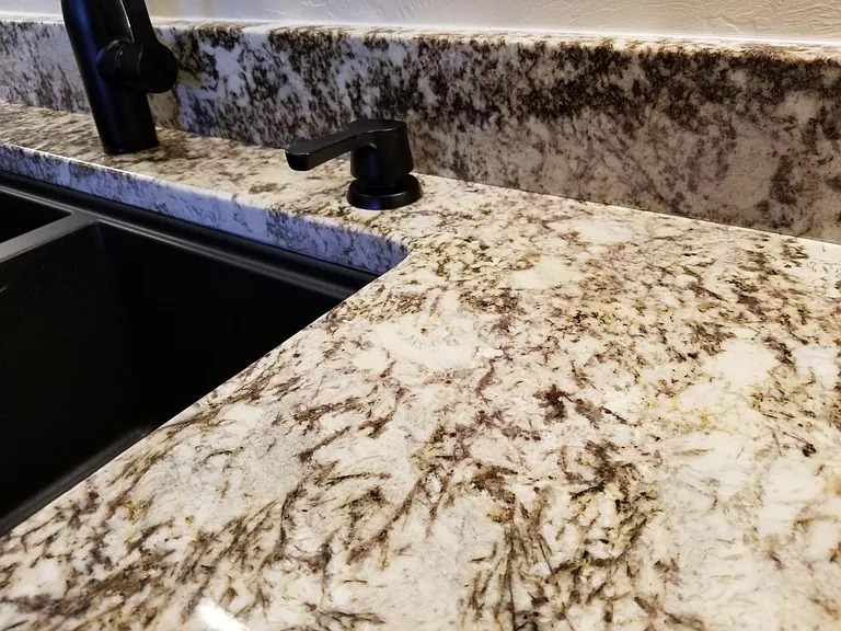 Details - closeup of 3 cm granite and fixtures in kitchen