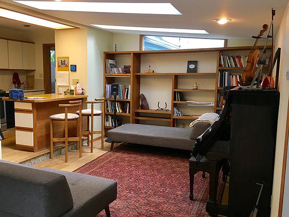 Living room with built-ins and skylights.