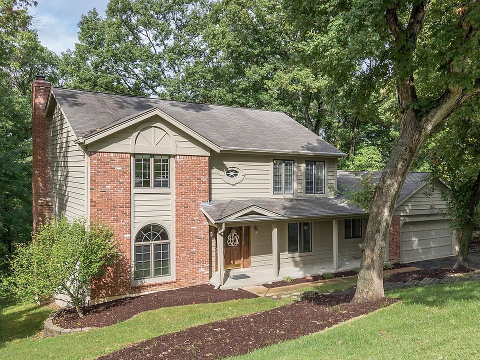 627 Shadowridge Drive - tucked away on a .86 acre lot with charming covered front porch