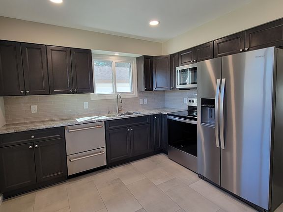 Brand New Kitchen Cabinets with Full-Overlay and Soft-close doors. All New stainless appliances including a Fisher & Paykel Double Drawer Dishwasher and Counter Depth Fridge. Quartzite countertops. New Tiled floor and backsplash. Stainless steel sink.