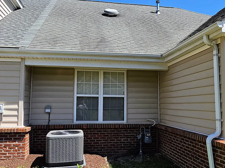 Meticulously maintained mechanical exterior featuring a modern, high-efficiency central A/C condenser unit to keep utility costs low (installed in 2025).