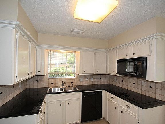 The kitchen has been recently updated with granite tile and stylish backsplash.