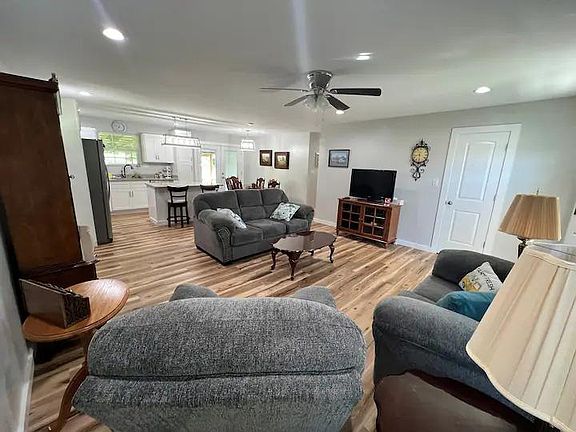The open floor concept can be well seen from this view showing the living room, dining area, and kitchen.