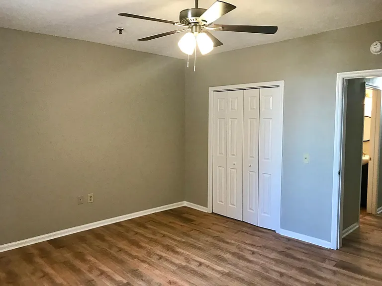 Large bedroom with back facing window