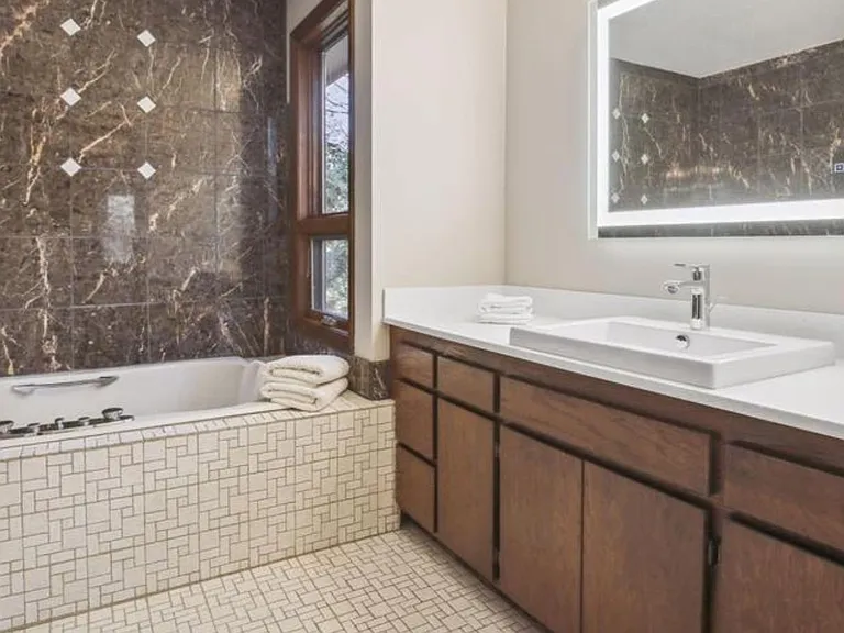 Spa quality full master bathroom with separate shower and 3 light mirror