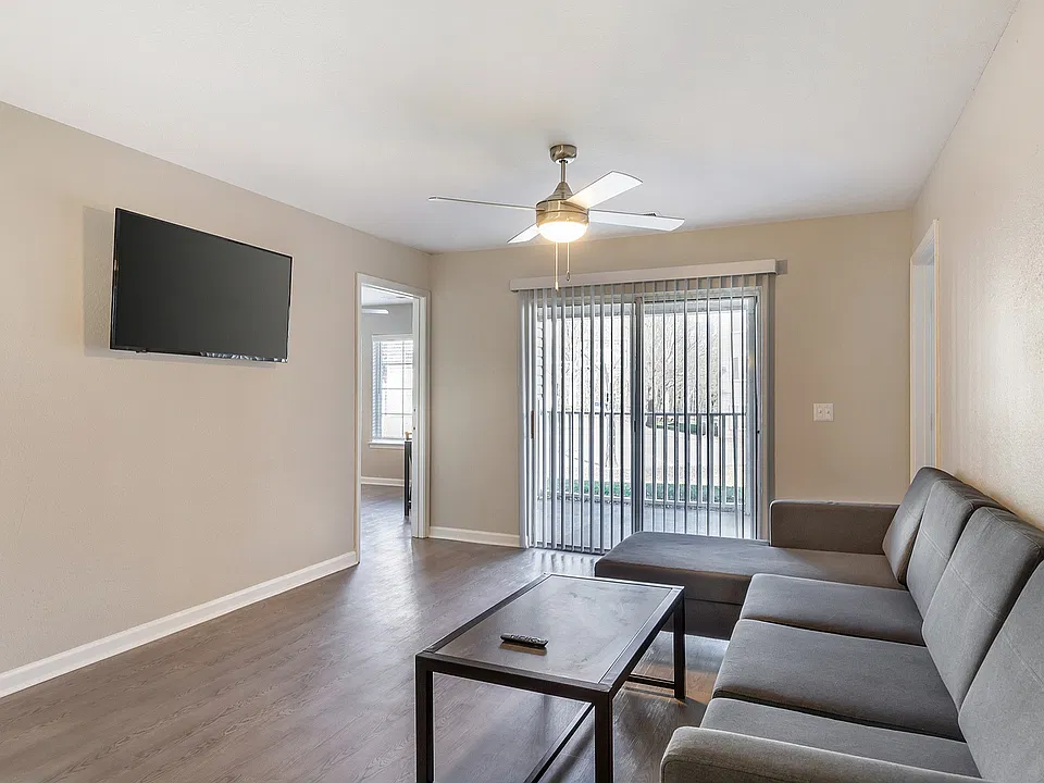Experience comfort and style in this spacious living room, complete with modern amenities and natural light.