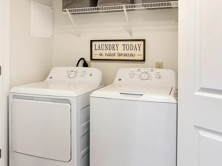 Convenient in-unit laundry tucked away for easy access.