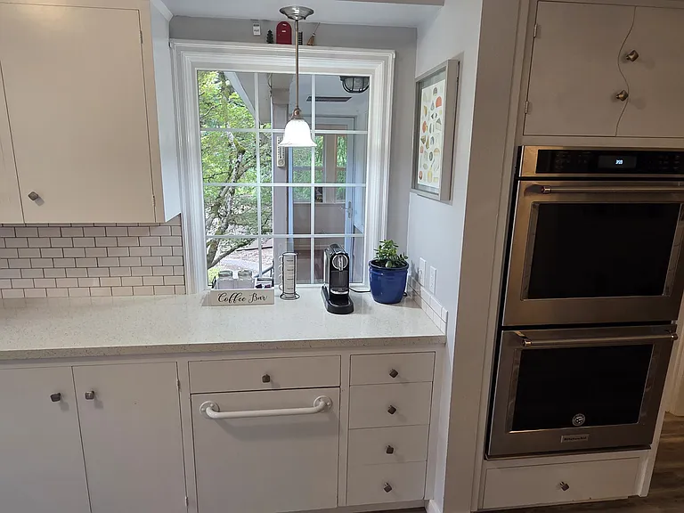 The beautiful kitchen includes a cozy coffee station with both an espresso machine and a coffee maker, so you'll have everything you need for your morning brew. Bake family favorites in the top-of-the-line KitchenAid double oven.