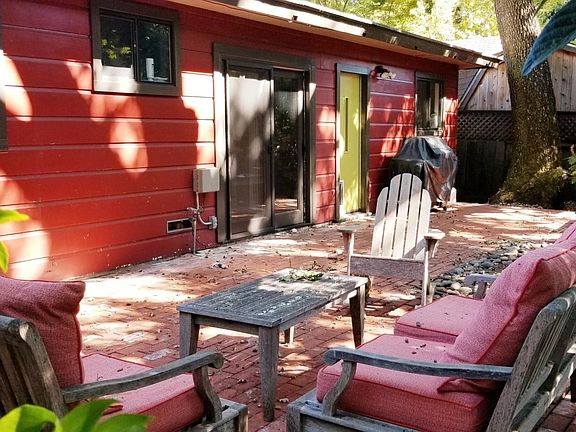 left window is bedroom #2, small window is bathroom, slider to dining room, separate door to kitchen, kitchen window over the si