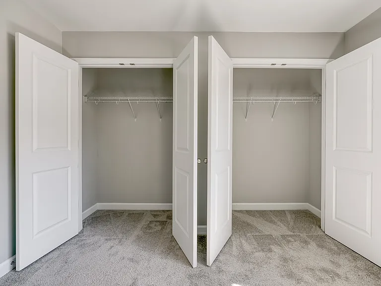 The main bedroom features his-and-hers closets with plenty of storage space.