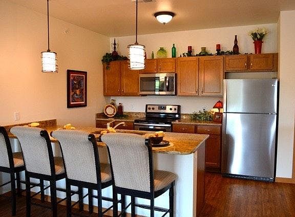 Kitchen with breakfast island, granite counters, and stainle