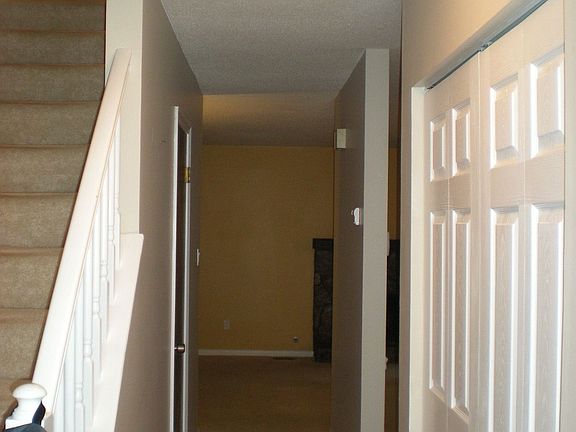 Entry with new closet doors, light fixture and wood flooring