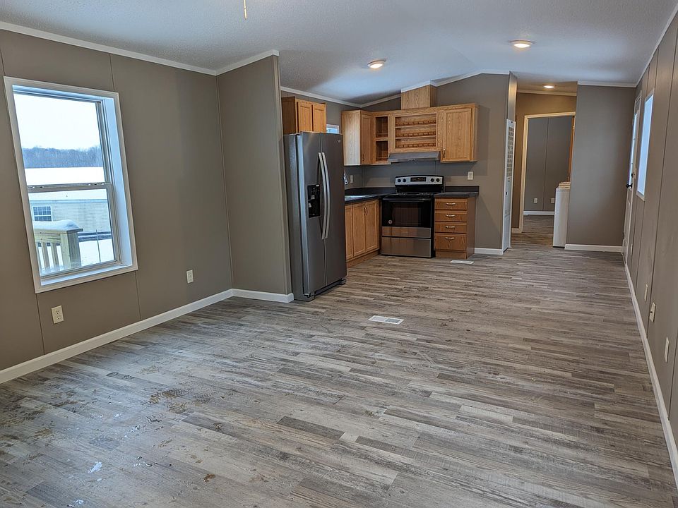 Living room dining nook and kichen with lots of natural lighting