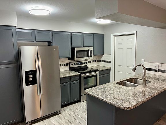 Beautiful Galley-Style Kitchen, Stainless Steel Appliances, Water and Ice in Refrigerator, Granite Counter Tops, Bright LED Lights, and a Breakfast Bar.